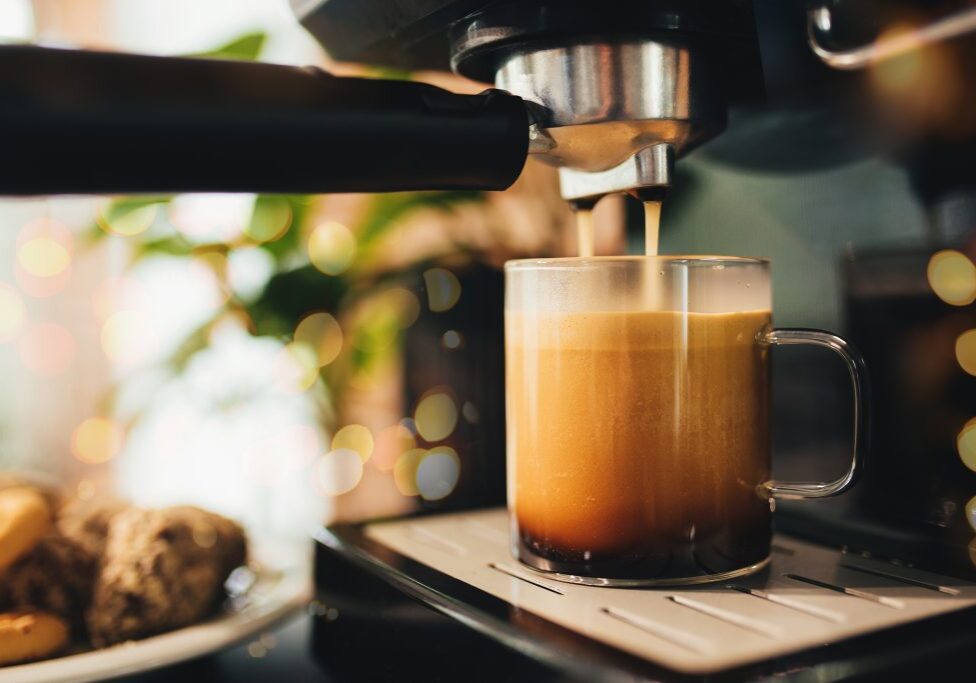 Cup of coffee at the coffee maker, coffee time. High quality photo