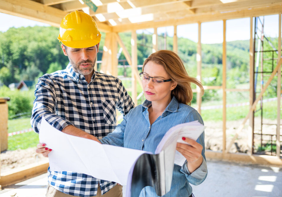 Woman and man looking over plans for a home build.